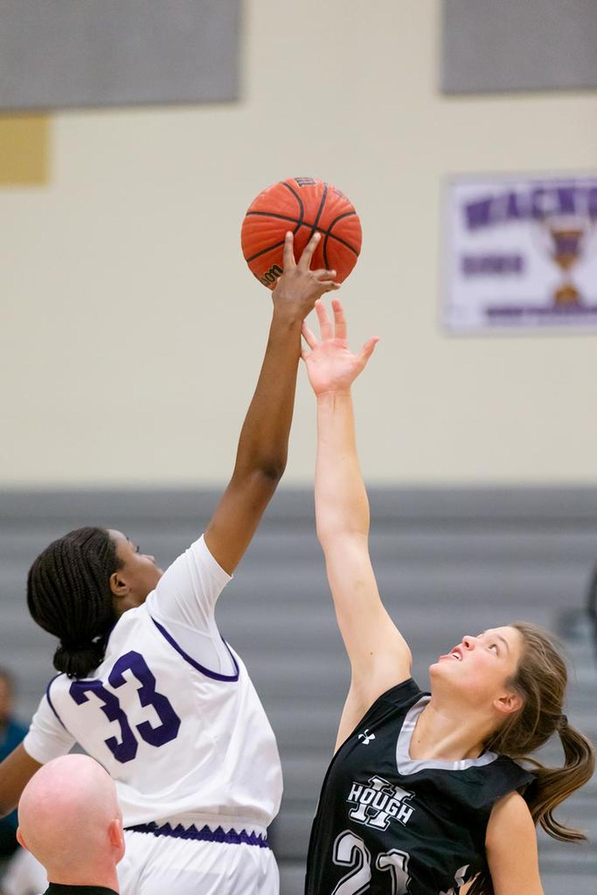 Ardrey Kell’a Michelle Ojo (33) wins the jump ball in Tuesday’s game with Hough. Tuesday Nov 27, 2018