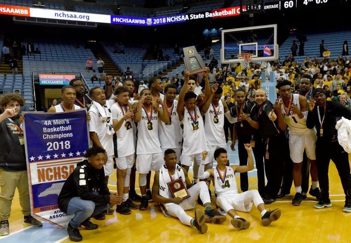 Independence players celebrate winning the state championship over Heritage after Saturday evening's NCHSAA state basketball championship 4A game between Independence and Wake Forest Heritage at the Smith Center in Chapel Hill.
