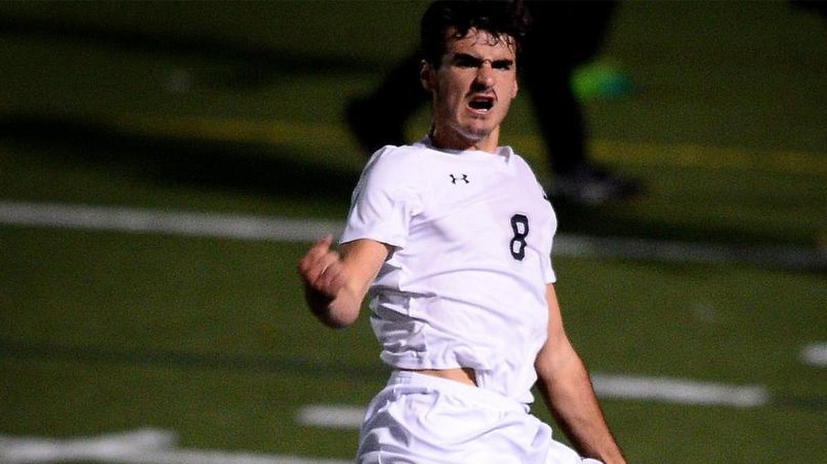 Hough Huskies Jackson Raymer leaps into the air with fists clenched after scoring a goal against the Providence Panthers at Hough High School on Tuesday, November 14, 2017. The two teams were playing in state semifinals action on Tuesday.