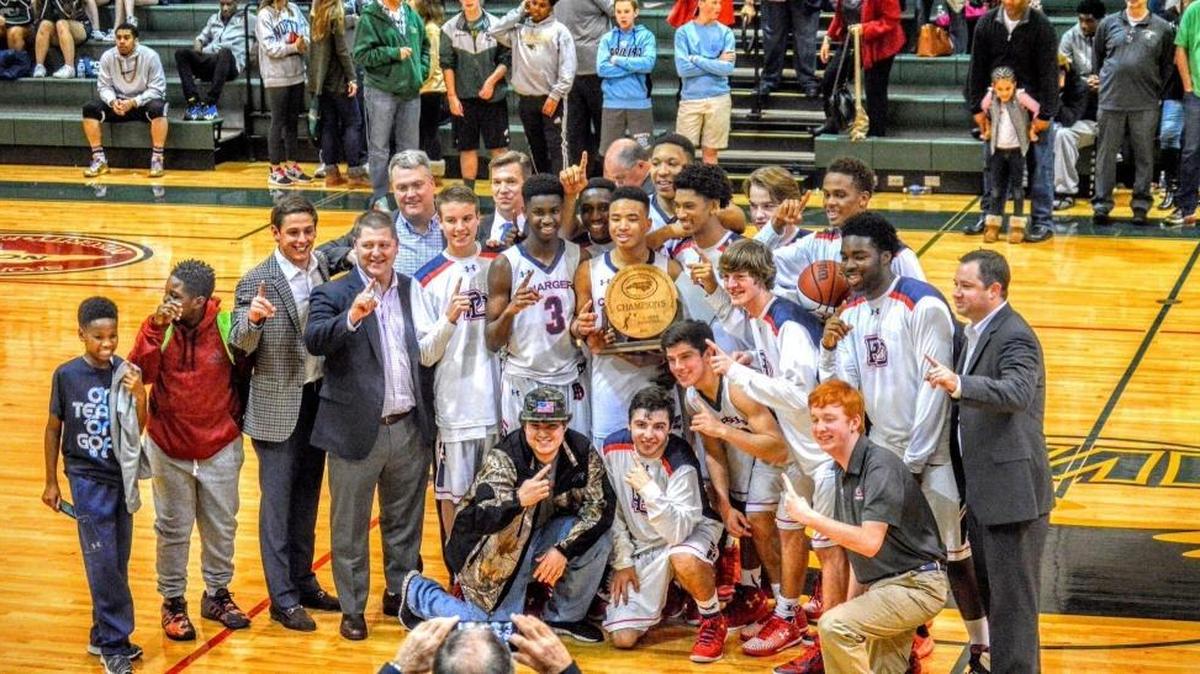 Providence Day’s boys basketball team celebrates winning its first N.C. state basketball championship since 1999