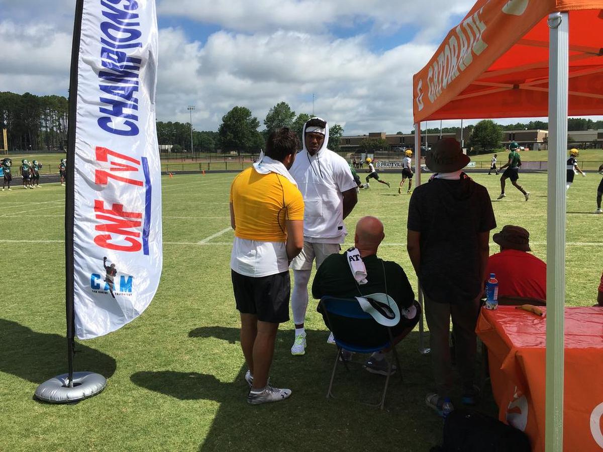 Sun Valley quarterback Sam Howell (left) and Panthers quarterback Cam Newton (right) chat during the Cam Newton Foundation 7-on-7 Tournament at Northwestern High in Rock Hill.