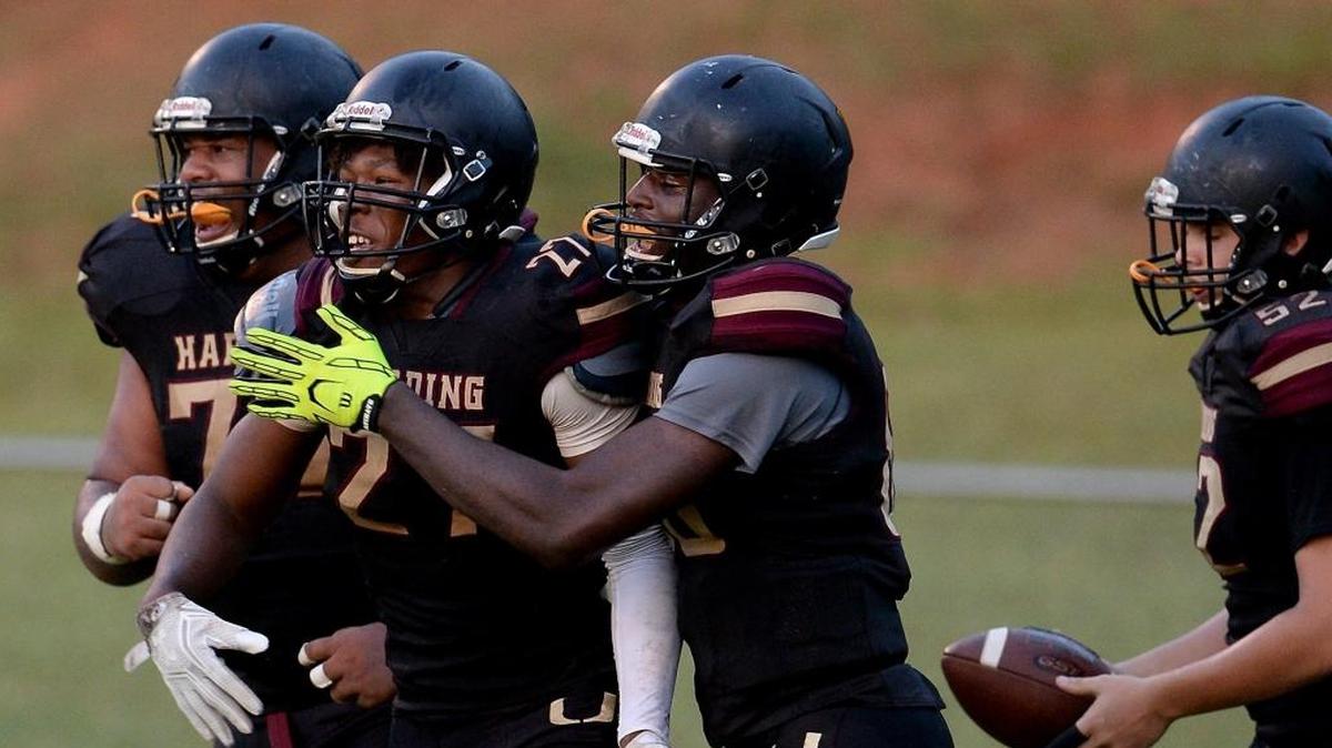 Harding University running back Quavaris Crouch, center, is among Observer high school football players of the week