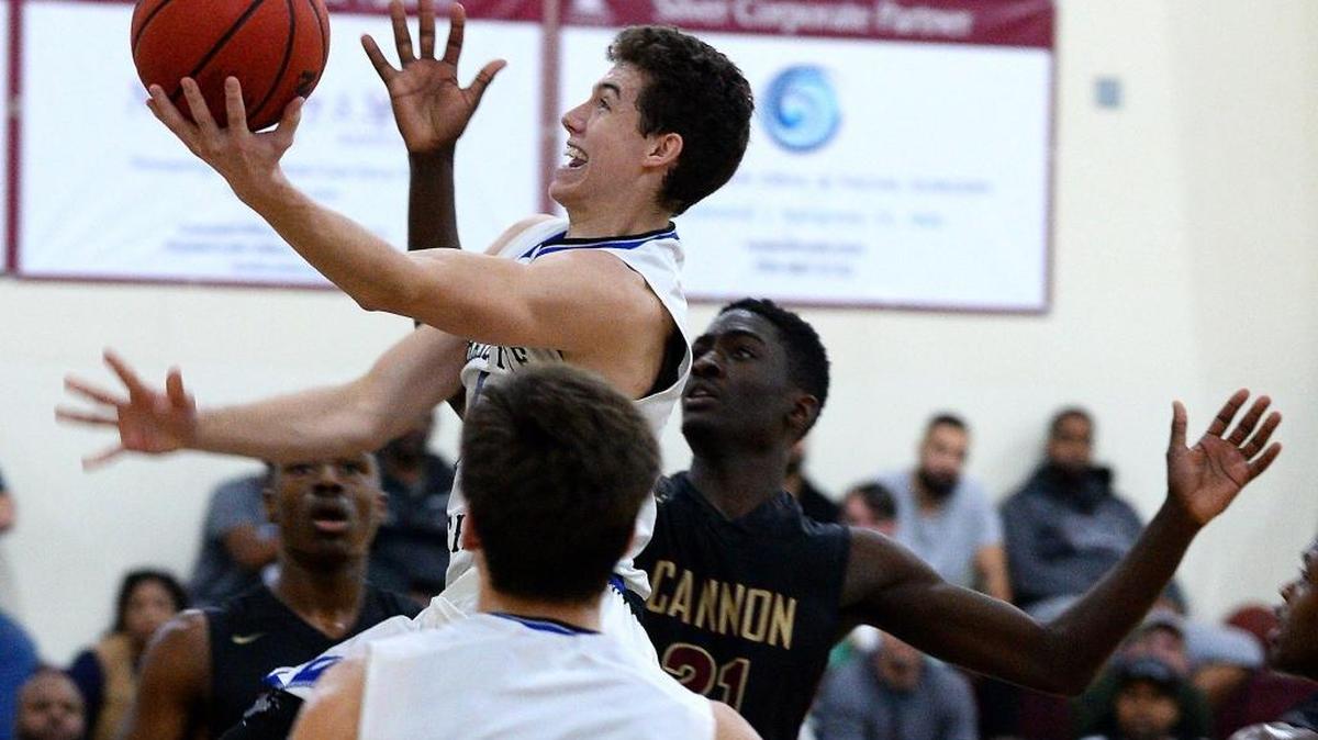 Charlotte Christian's Robert Peterson drives the lane to the basket as Cannon School defender Qon Murphy, right, looks on during action on Tuesday, January 17, 2016 at Cannon School in Concord, NC. Charlotte Christian defeated Cannon School in double overtime 76-71.