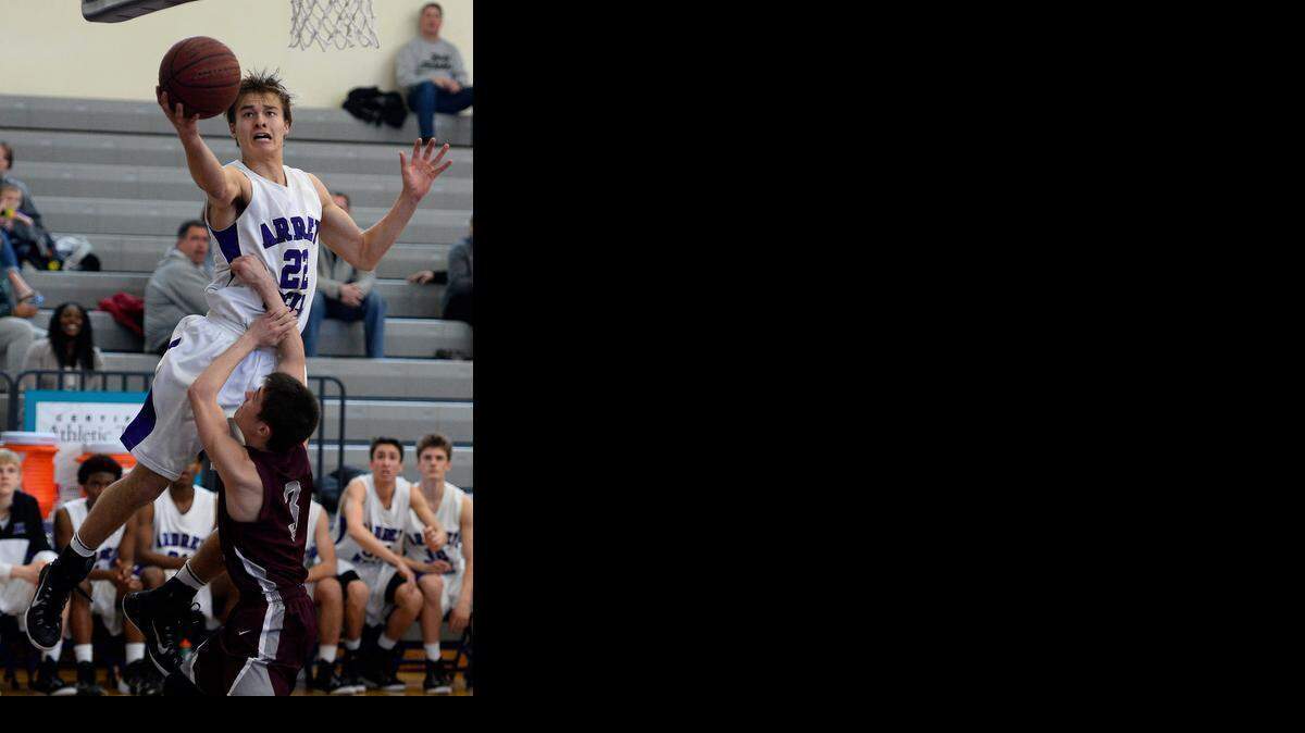 
Ardrey Kell's Steven Santa Ana (22) drives to the basket for a shot over South Caldwell's Kam Kincaid (3) during first round NCHSAA playoff action on Saturday February 28, 2015 at Ardrey Kell High School in Charlotte, NC
