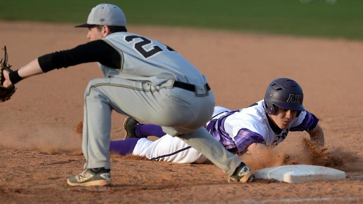 Ardrey Kell runner Nathan Crenshaw, right, dives safely back into first base as Providence first baseman Zach Brown, left, fields the ball during SoMeck 8 baseball action on Friday.