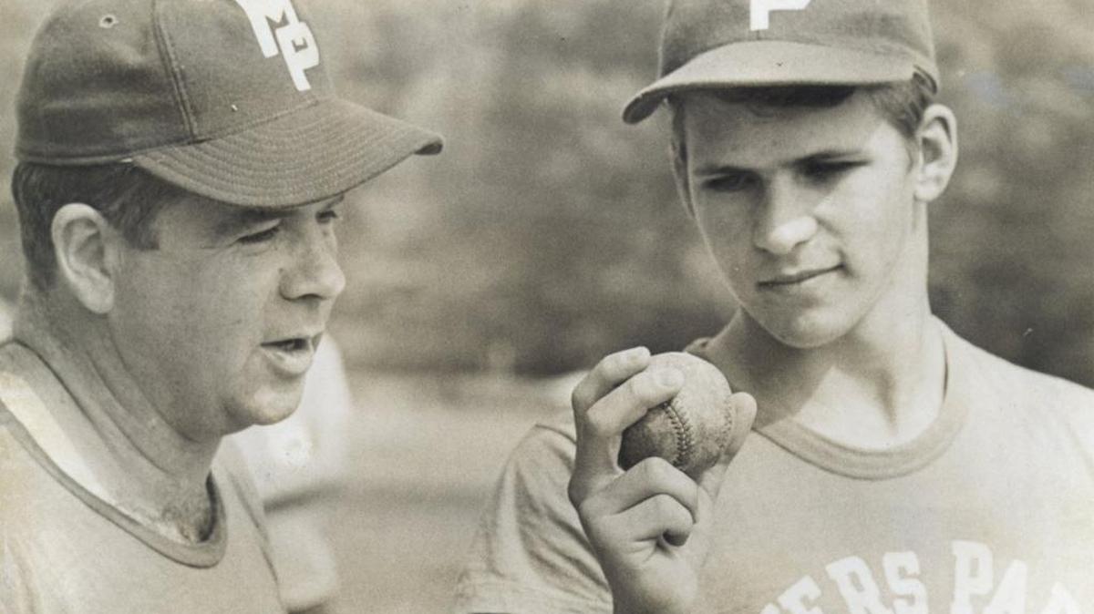 Myers Park top pitcher Brad Biggers (R) confers with coach Jack Sink in an Observer file photo