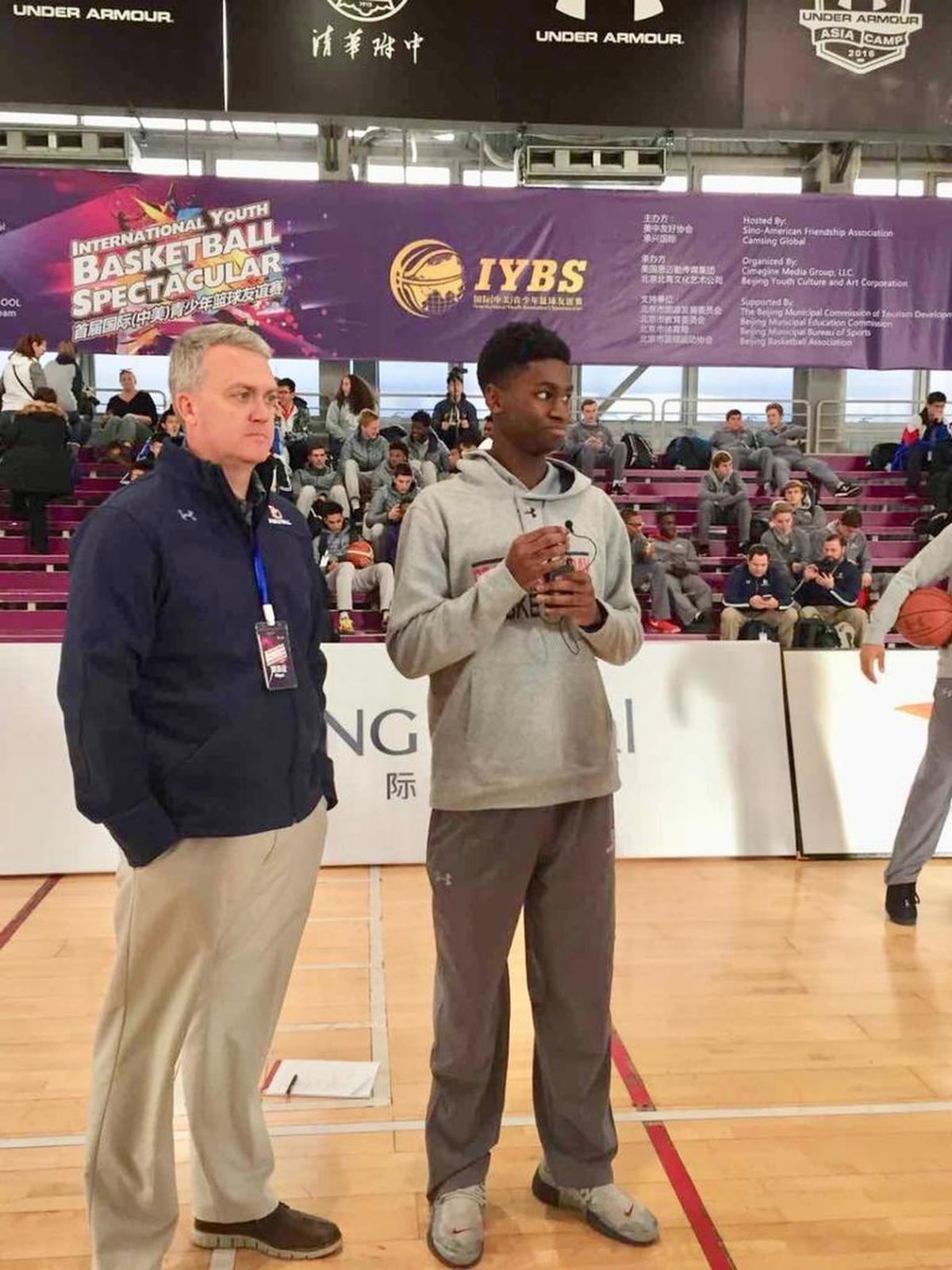 Providence Day senior Trey Wertz, a Santa Clara signee, spoke for his school during the opening ceremonies for the first International China-US Youth Basketball Spectacular. With Wertz is Chargers’ coach Brian Field