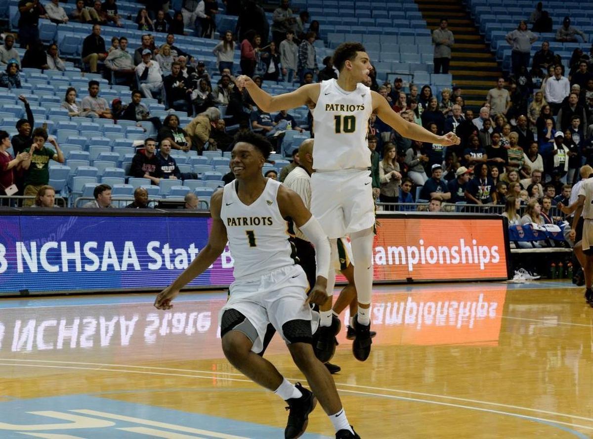 Independence players celebrate winning the state championship over Heritage after Saturday evening's NCHSAA state basketball championship 4A game between Independence and Wake Forest Heritage at the Smith Center in Chapel Hill.