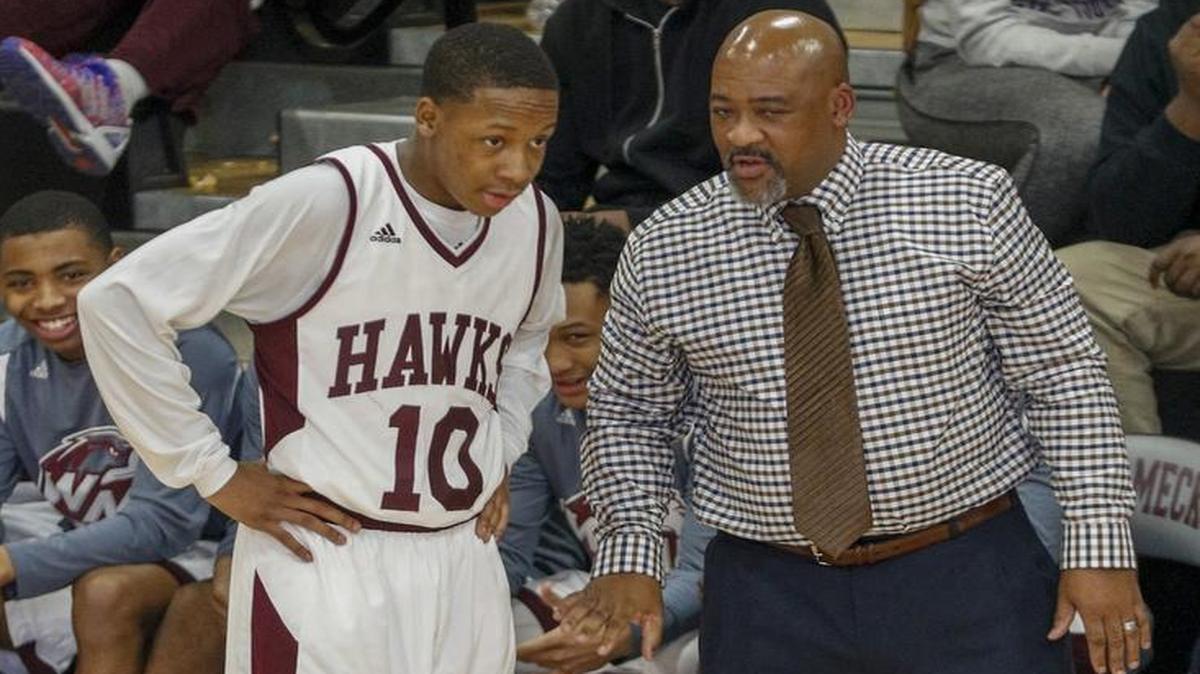 West Meck coach Robert Hollis III talks to guard Jalen Moore as West Meck plays South Meck in the first half of a high school basketball game in Charlotte, N.C., Friday, Jan. 27, 2017. (Nell Redmond photo)