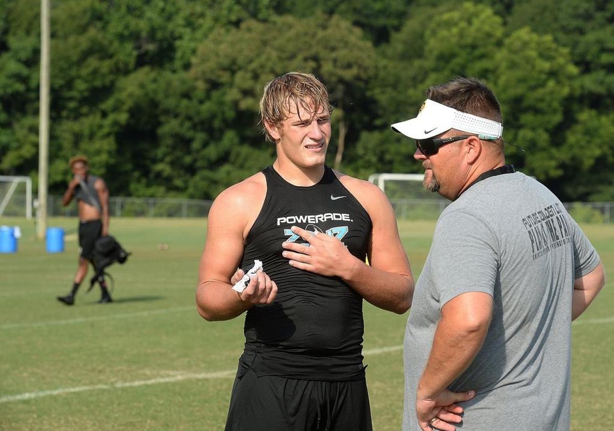 Shelby High LB Dax Hollifield talks with coach Lance Ware at practice. Hollifield is a national player of the year finalist