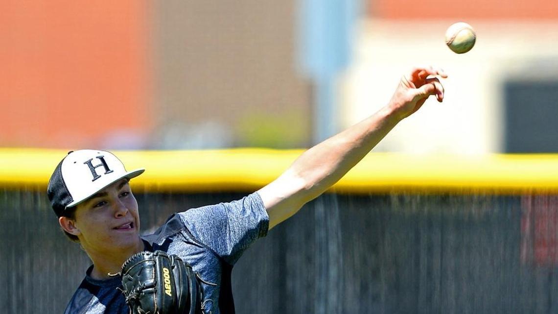 Hough High pitcher JD Brock warms up during practice.