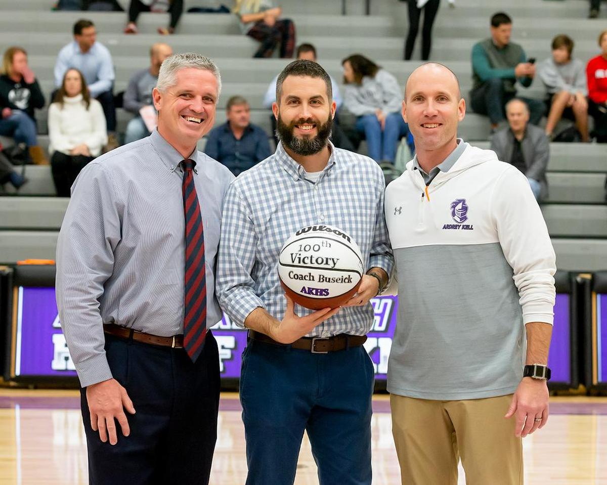 Ardrey Kell girls basketball coach Jeff Buseick (middle) was recognized for his 100th career win Tuesday