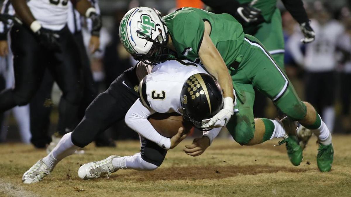 Myers Park linebacker Jake Harkleroad tackles Providence quarterback Mason Boothe in the first round of Friday night’s N.C. 4AA playoff football game. Myers Park won 55-7.