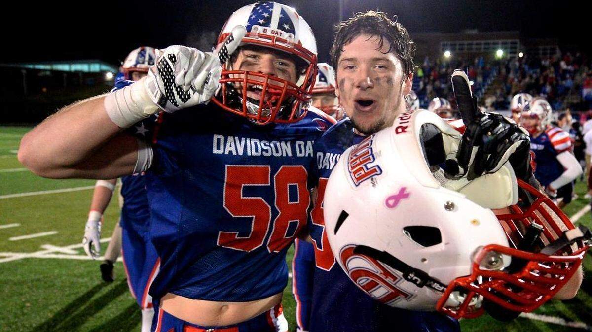 Davidson Day's linebacker Chase Monroe, left, and defensive end Garrett Grouix, right, celebrate the team's victory over Charlotte Latin 31-13 in the private school's state football championship game on Friday, November 13, 2015 at Charlotte Christian School in Charlotte, NC.