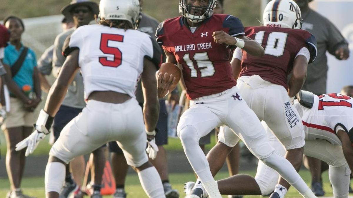 Mallard Creek quarterback Jadyn Washington (15) looks for room around the Butler defense during a varsity football game at Mallard Creek High School Friday, August 25, 2017 in Charlotte, NC. Photo by JASON E. MICZEK - Special to the Observer