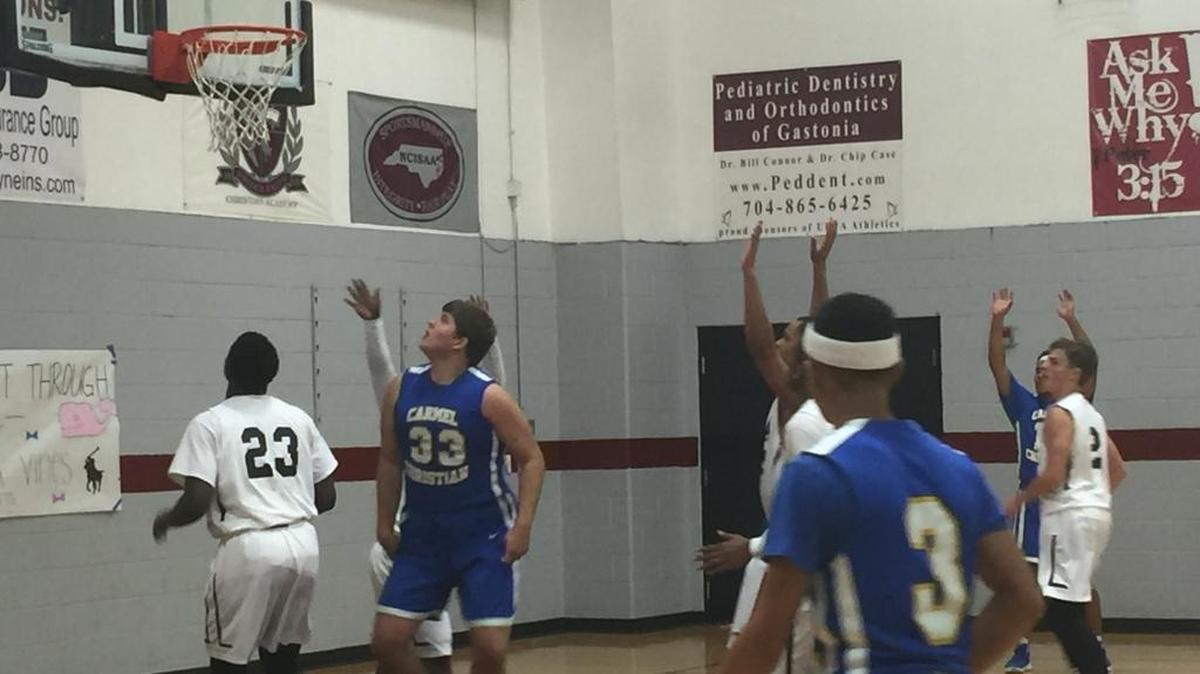 United Faith’s Jon Hicklin (left) and Carmel Christian’s Mac Brydon watch a shot go up during Carmel’s 88-76 SPAA win at sold-out United Faith Thursday