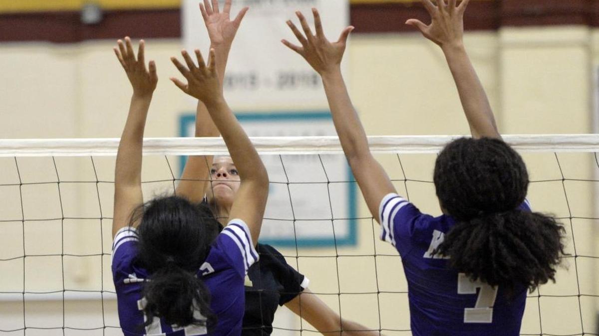 Providence’s Carly Peck taps the ball over Ardrey Kell’s Morgan Hanchard (14) and McKayla Young (7) during the SoMeck 8 Conference volleyball championship match on Wednesday.