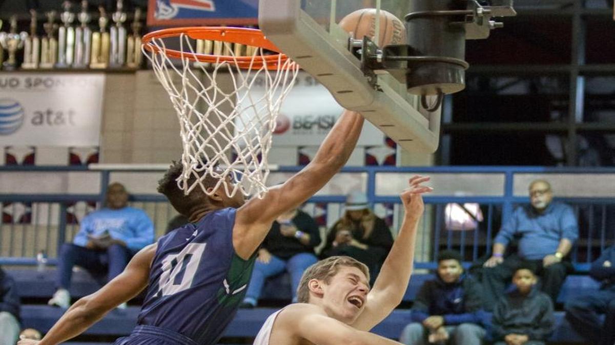 Wynston Tabbs (10) of St. Mary's Ryken, gets the block during late 2nd half action as they played DeMatha Catholic at the Hoodies House High School Hoops Classic hosted by Providence Day High School.
