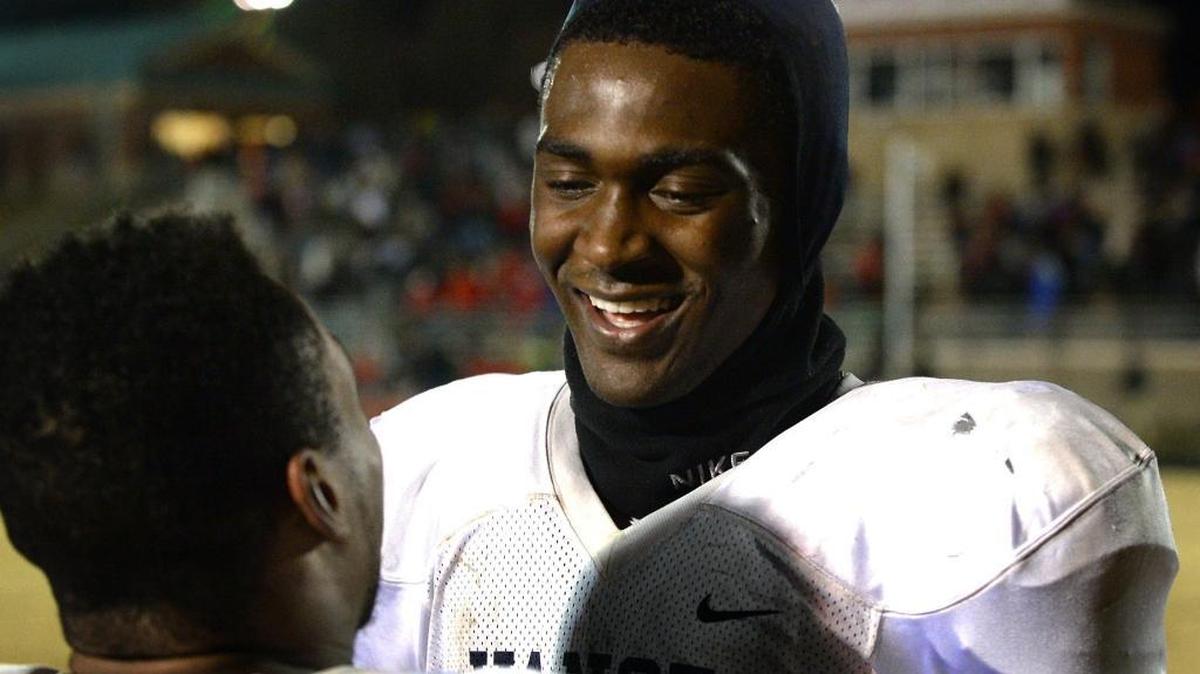 Vance Cougars quarterback Kingsley Ifedi, right, smiles as he is congratulated by a teammate following their victory over the Butler Bulldogs during overtime at Butler High School on Friday, December 2, 2016. Vance defeated Butler 50-49.