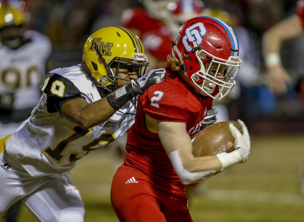 Kings Mountain cornerback Belton Pressley, left, tries to tackle Charlotte Catholic running back Paul Neel in the first half of Friday’s N.C. 3A regional final.