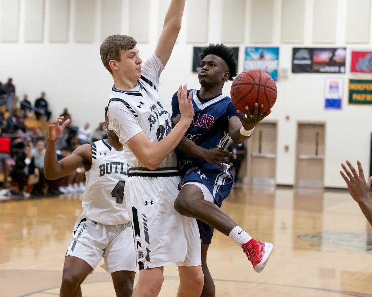 Butler’s Patrick Wessler (left) blocks the layup attempt by the Mallard Creek guard.