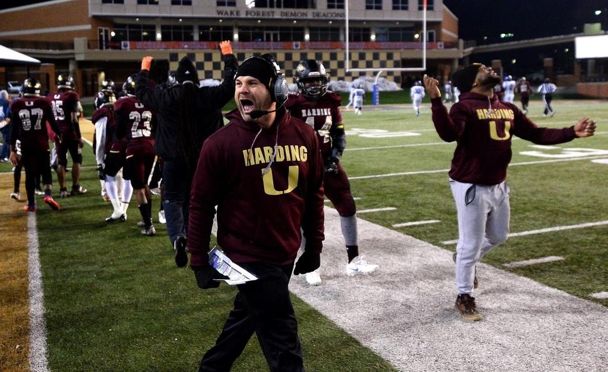 Harding University head coach Sam Greiner celebrates quarterback Braheam Murphy's 95-yard touchdown against Scotland County during fourth quarter action in the NCHSAA 4A State Championship game at BB&T Field in Winston-Salem, NC on Saturday, December 9, 2017. Harding defeated Scotland County 30-22.