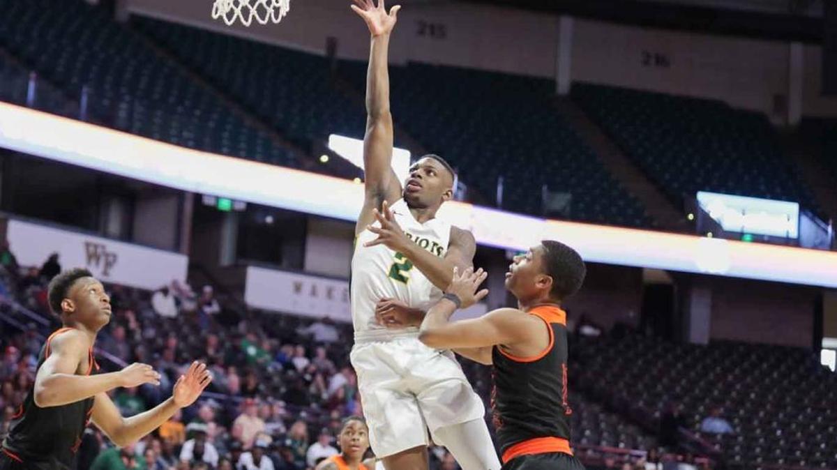 Independence’s Jamarius Burton drives the lane for a layup against Rocky River on Saturday. Burton and the Patriots beat the Ravens 72-45 in the 4A regional final in Winston-Salem.