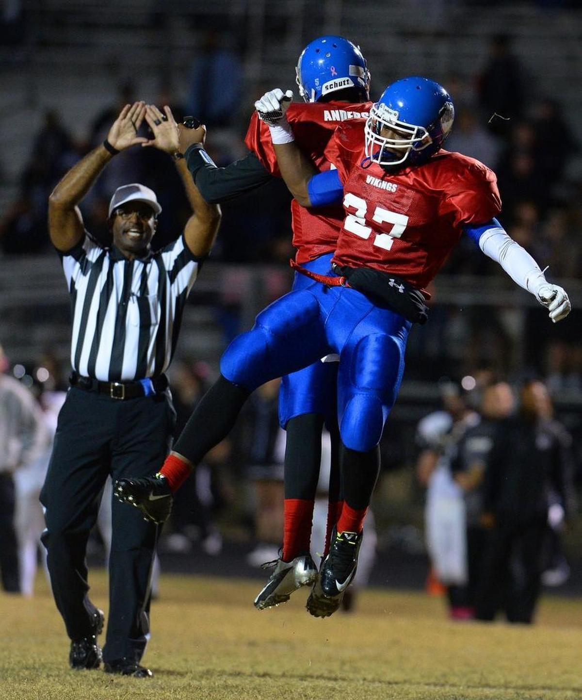 North Meck quarterback Jaelan Anderson, left, and running back Emanuel Wilson, right, celebrate in a game in 2017. 