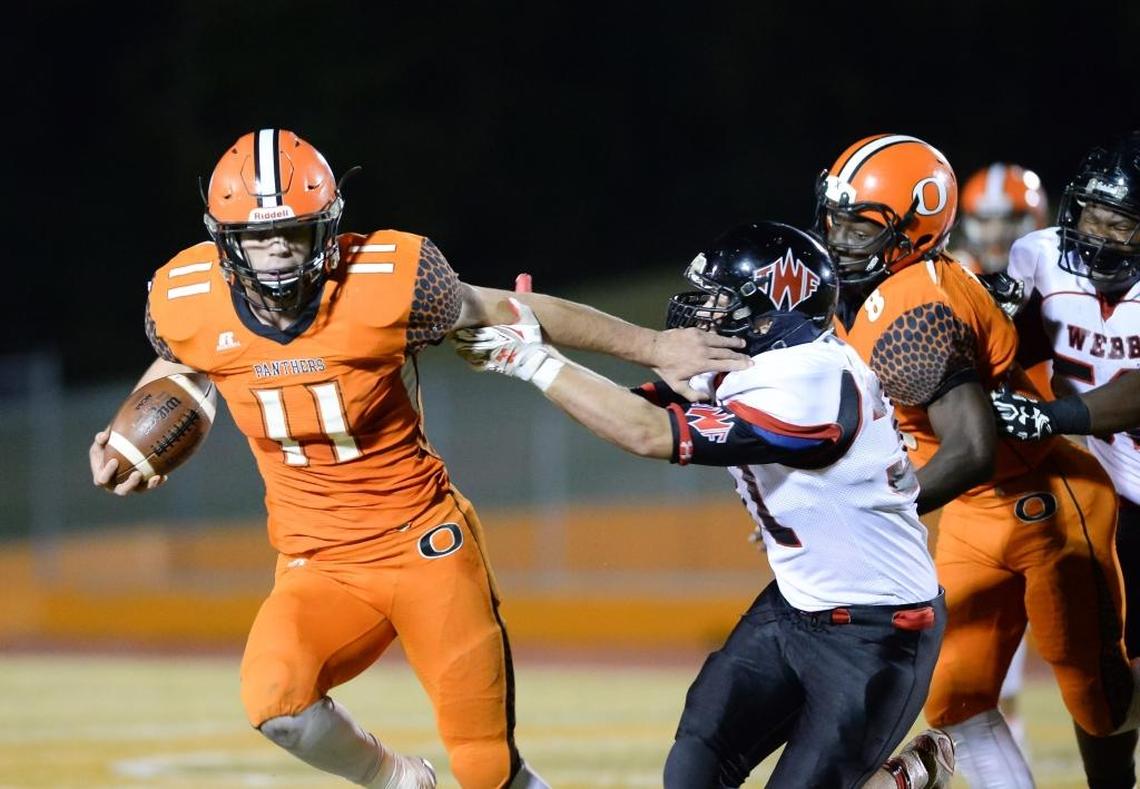 Hillsborough Orange’s Payton Wilson (11) stiff-arms Webb’s RJ Crews.