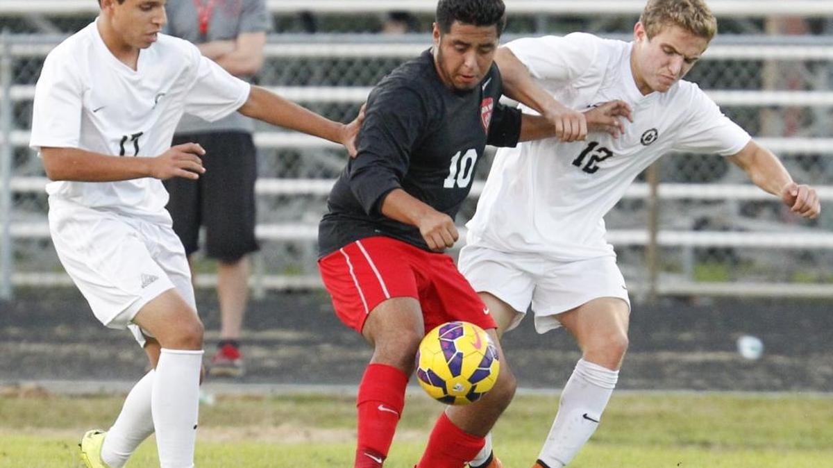 South Meck's Brandon Garcia (10) tries to get away from Providence defenders during a prep soccer match at Providence last month. The teams play again in the state semifinals Tuesday at South Meck. Photo by JASON E. MICZEK - Special to the Observer