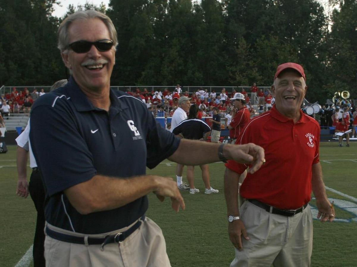 In 2007, Charlotte Latin head coach Larry McNulty, left, shares a pre-game laugh with now retired Charlotte Catholic head coach Jim Oddo at Patten Field at Charlotte Latin High School Friday