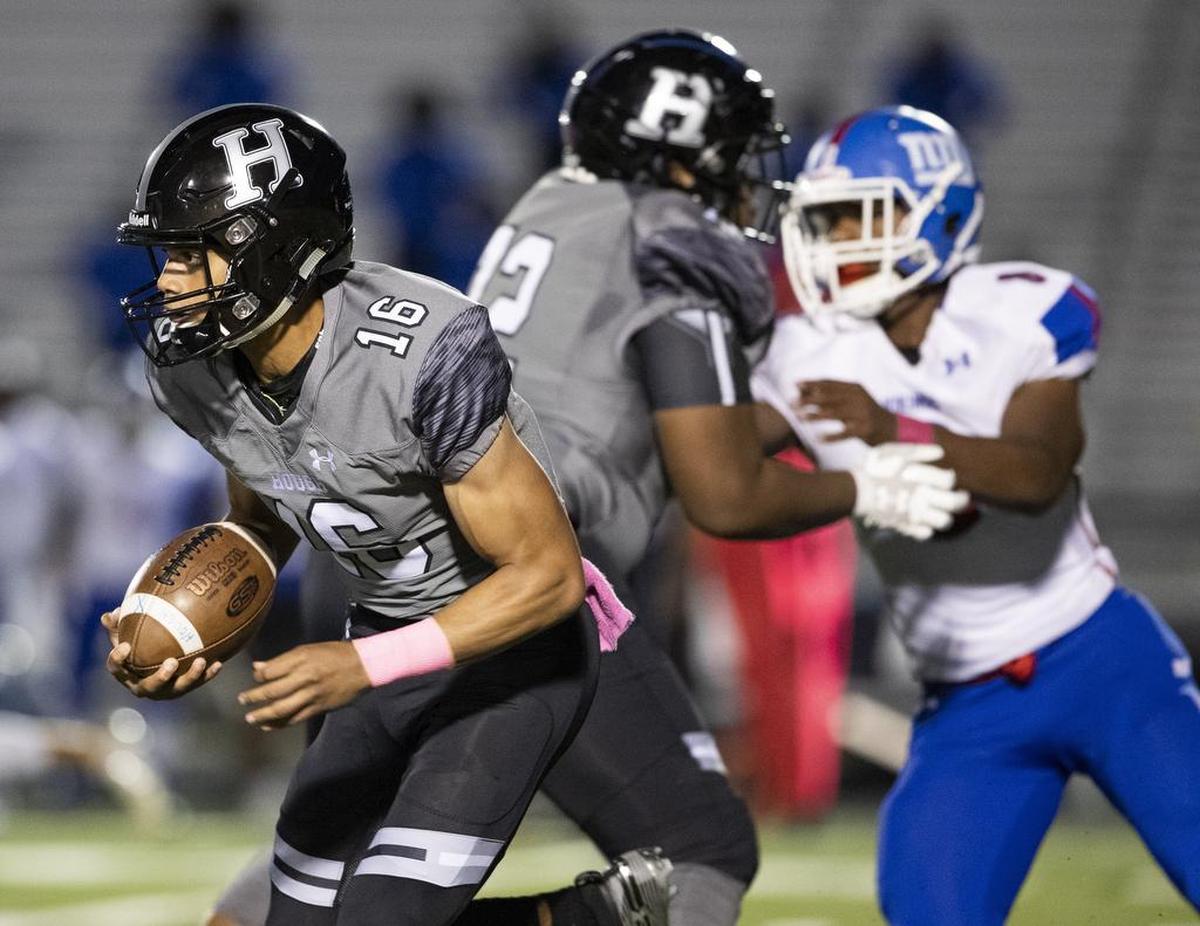 Hough quarterback Elijah Johnson, left, looks for running room against visiting North Meck on Friday.