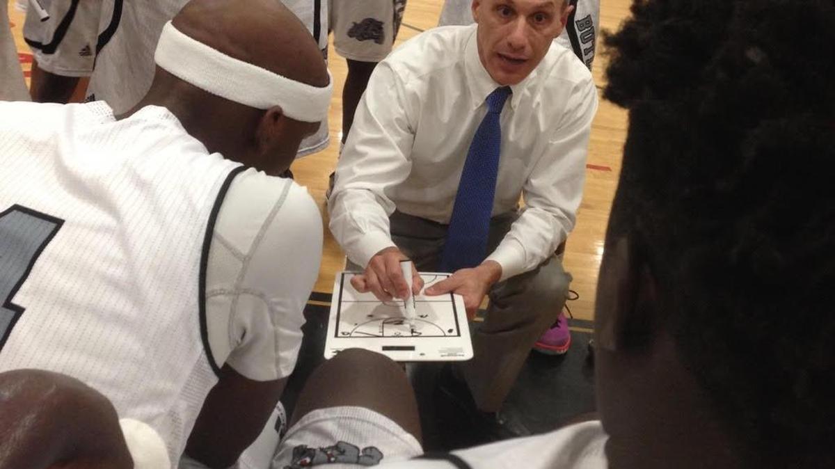 Butler High coach Myron Lowery talking to his team during a timeout