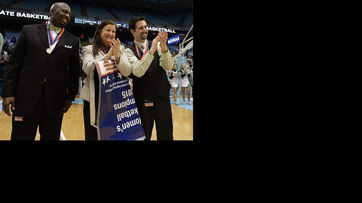 
(Center) Myers Park Mustangs head coach Barbara Nelson applauds as players receive their metals following their victory over Southeast Raleigh in the NCHSAA 4A Girls Championship game at the Dean E. Smith Center in Chapel Hill, NC on Saturday March 14, 2015. Myers Park defeated Southeast Raleigh 52-47
