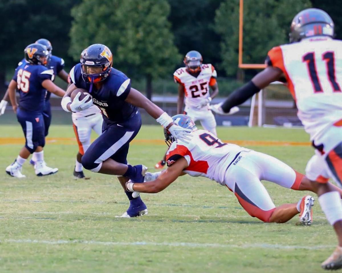 Rocky River’s Jaylon Sharpe (9) makes an open-field tackle on Nigel Summerville (left) during the first quarter of Friday’s game at Vance.