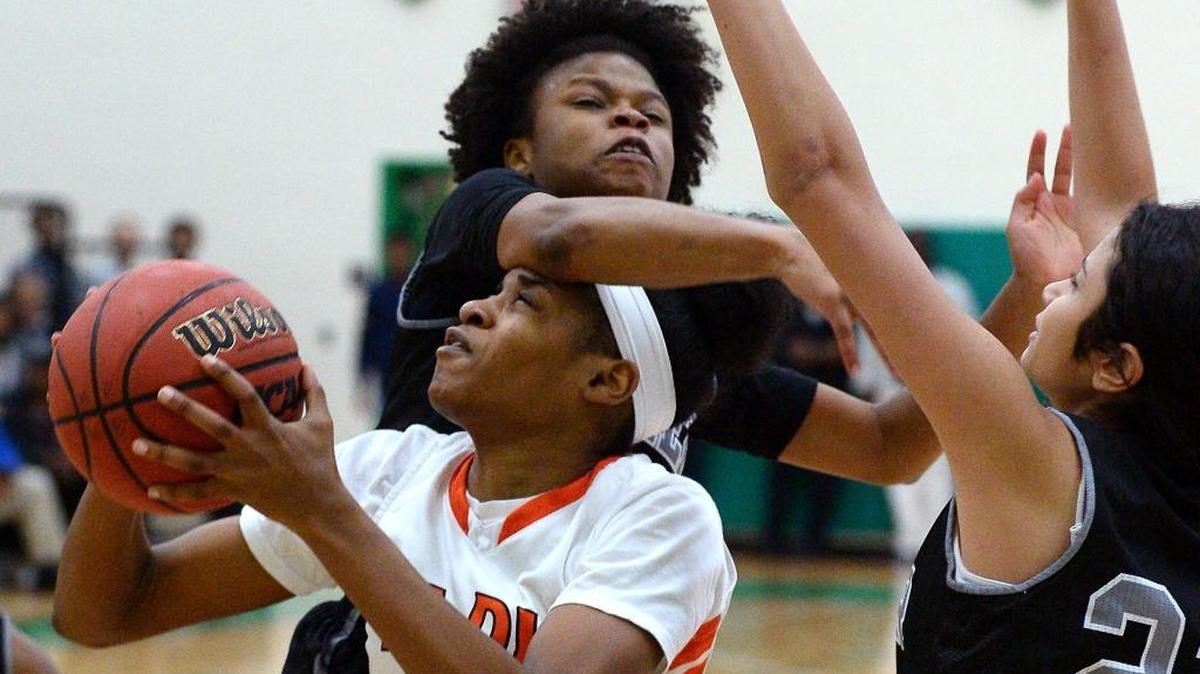 Rocky River's Cianie Jallah, front/center, takes a hard foul from Butler Bulldogs Jiani Bryant, top/center during the Southwestern 4A championship game action at Myers Park High School on Friday, February 17, 2017. Rocky River defeated Butler 56-34.