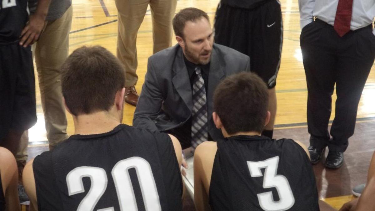 Hough coach Jason Grube talks to his team during a timeout. Hough defeated rival Hopewell Thursday
