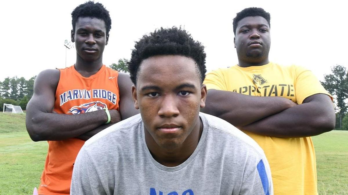 There are high expectations this football season for Marvin Ridge High and Mavericks receiver Emeka Emezie, left, linebacker-running back Caleb Deveaux and offensive lineman Dmitri Emmanuel, all considered major-college prospects.