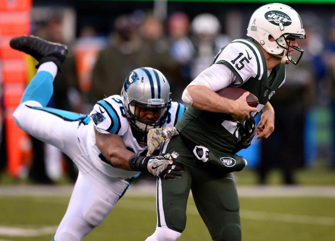 New York Jets quarterback Josh McCown, right, has spent part of his offseason at Myers Park High, where he’s served as a de facto assistant coach to Scott Chadwick. Above, Carolina Panthers defensive end Wes Horton, left, pressures McCown into losing the ball, which was recovered by Luke Kuechly and returned for a touchdown, in last fall’s game in East Rutherford, N.J.