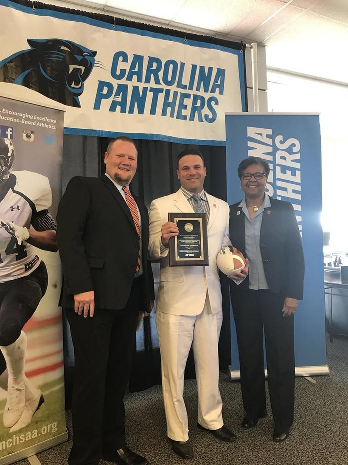 Harding High coach Sam Greiner with NCHSAA commissioner Que Tucker (right) and assistant commissioner Tra Waters
