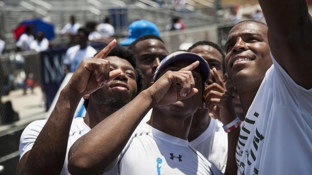 Panthers quarterback Cam Newton takes a selfie with Southern Guilford’s football players during his 7-on-7 tournament last June.