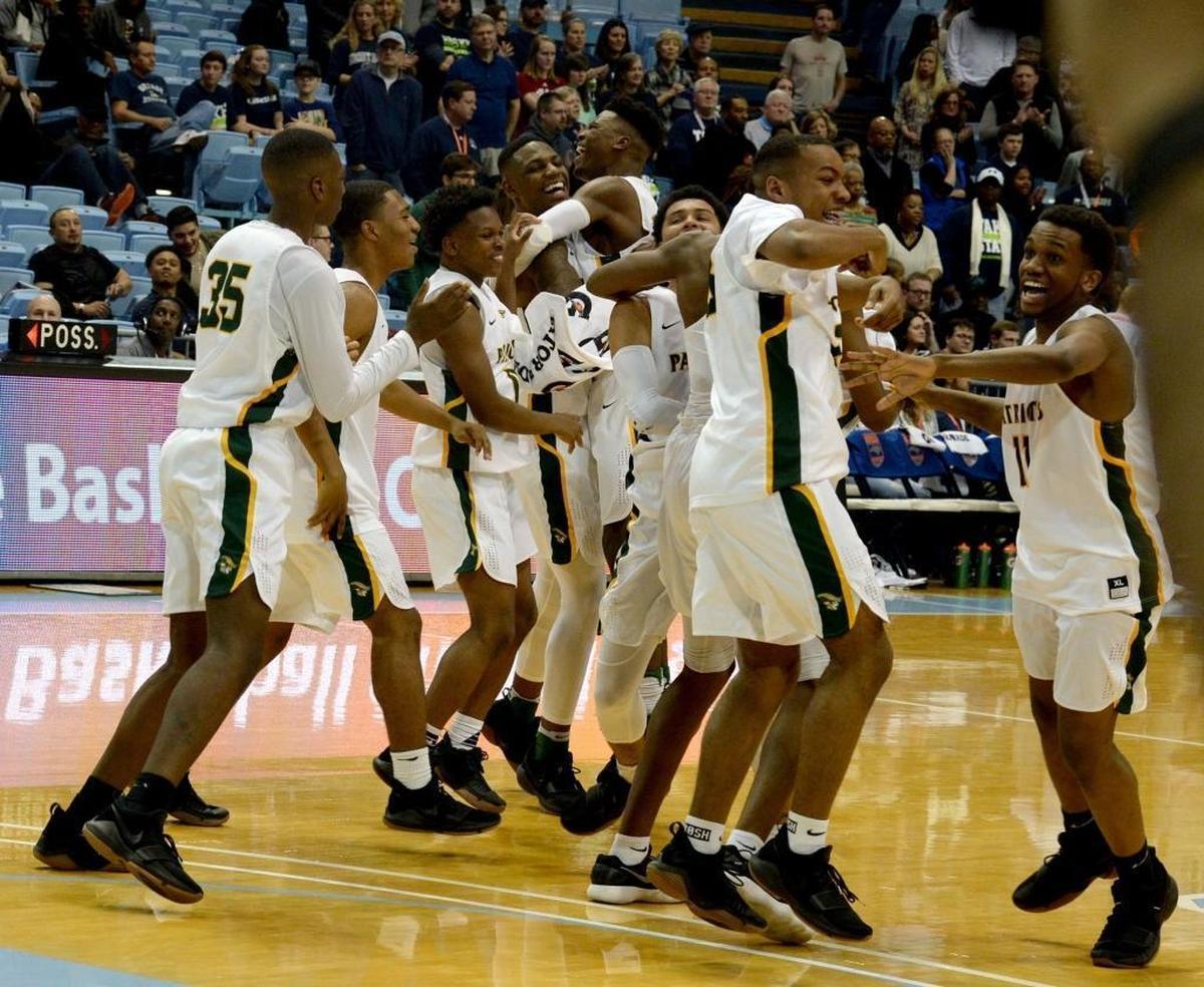 Independence players celebrate winning the state championship over Heritage after Saturday evening's NCHSAA state basketball championship 4A game between Independence and Wake Forest Heritage at the Smith Center in Chapel Hill.