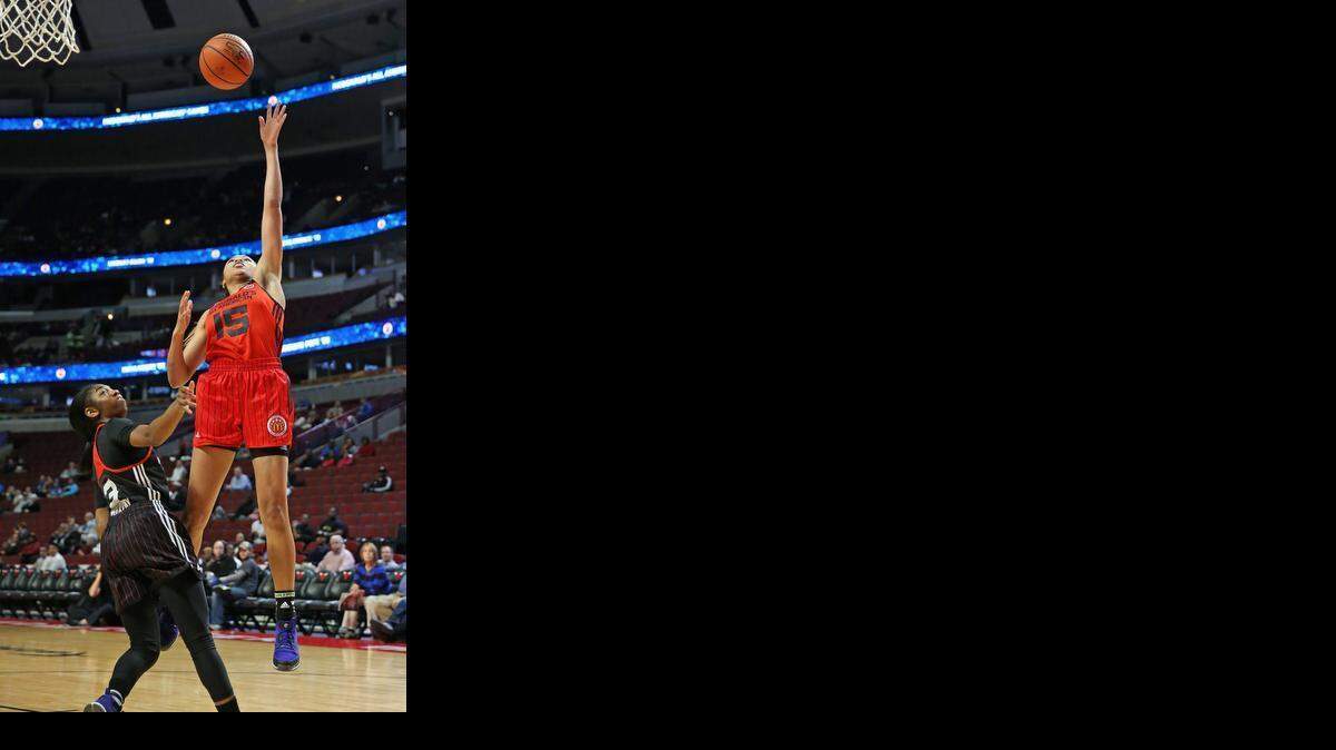 
Stephanie Watts (#15) of the West teams shoots over Taylor Murray of the East team during the 2015 McDonalds’ All-American Game at the United Center on April 1, 2015, in Chicago.
