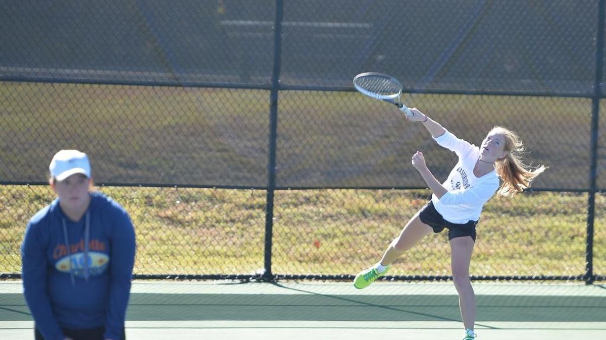 Olivia Archer of Lake Norman Charter hits a serve while her teammate Zoe Panizza, left, prepares for a return during the women dual team tennis games between the N.C. School of Science and Math Unicorns and the Lake Norman Charter Knights that took place at the Burlington Tennis Center in Burlington, N.C. on Saturday, November 12, 2016.