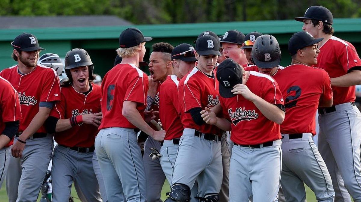 Butler players celebrate as Butler #8 Kobe Phillips (fourth from left) reaches home after hitting a three run homer during Friday's Butler at Myers Park matchup in a battle of teams tied for first place in the Southwestern 4A baseball standings.