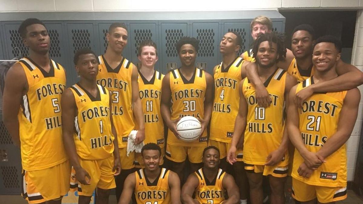 Forest Hills High junior Jai Rorie (center, with ball) and his teammates after Wednesday’s win