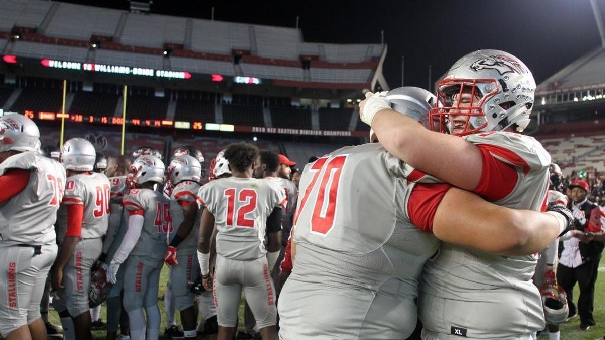 South Pointe's Jackson Campbell, right, and Jaydon Collins hug after the players win the S.C. 4A state championship title in Columbia earlier this month.