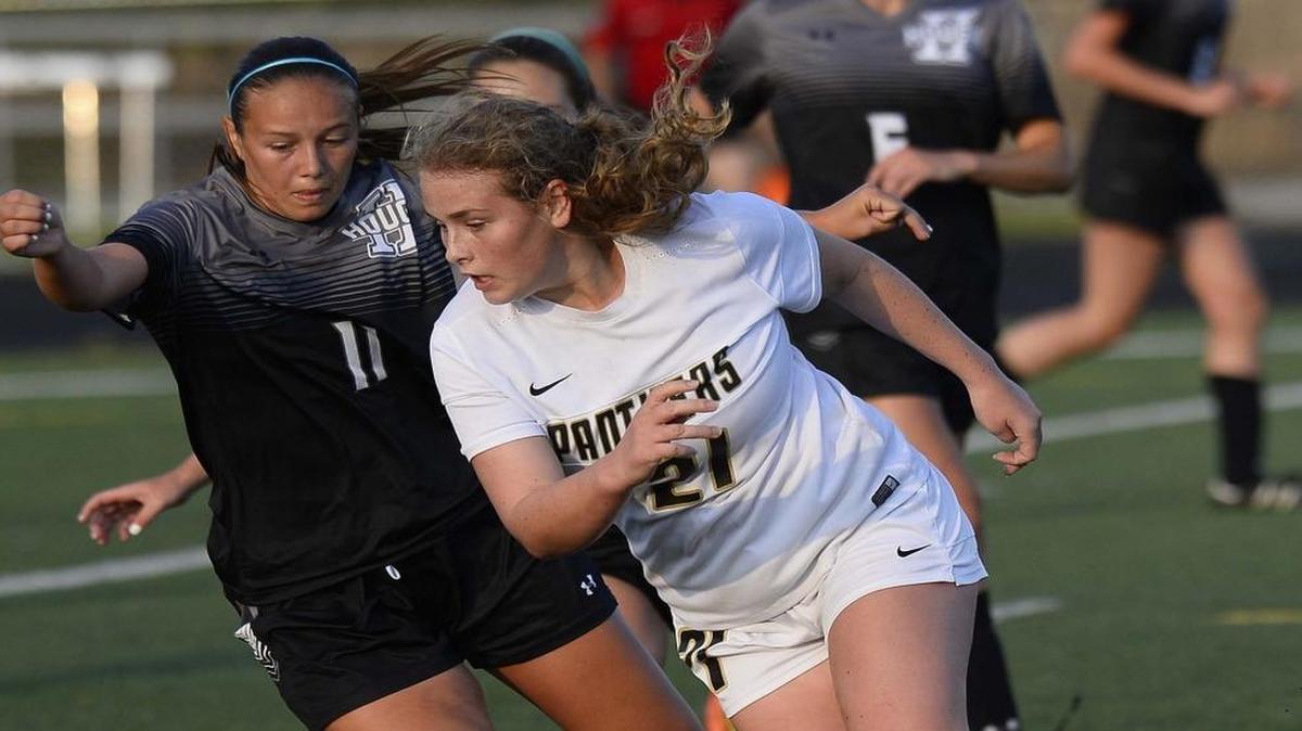 Providence high's Molly McGary on right, chases down the ball against Hough high's Anna Roach on left, during Wednesday night's third round playoff match played at Rocky River high school May 18, 2016. Providence high defeated Hough high 2-0.