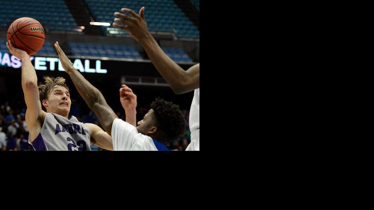 
Ardrey Kell’s Steven Santa Ana releases a shot over the outstretched hands of Garner defenders during the during the N.C. 4A boys’ championship game at the Smith Center in Chapel Hill on Saturday. Garner defeated Ardrey Kell 70-64. Santa Ana scored 44 points.
