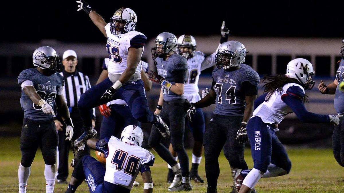 The Mallard Creek Mavericks celebrate a knocked-down pass interception by defensive lineman Monte Livsey against Butler last week.